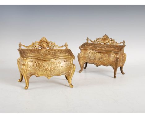 A pair of late 19th century French Rococo style gilt metal table top commode form boxes, decorated with figures, shells, flow