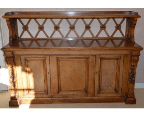 A Victorian oak buffet, the pierced gallery back supporting a rectangular shelf above a rectangular top, over a central fixed