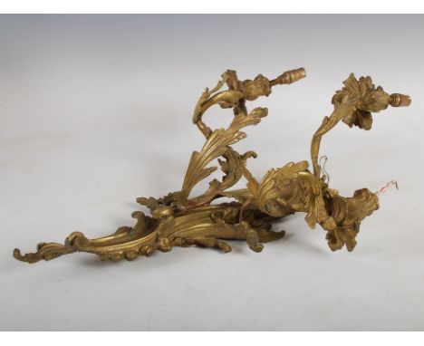 A late 19th/ early 20th century ormolu Rococo style three light wall sconce, with later electric fittings, 60cm x 38cm.