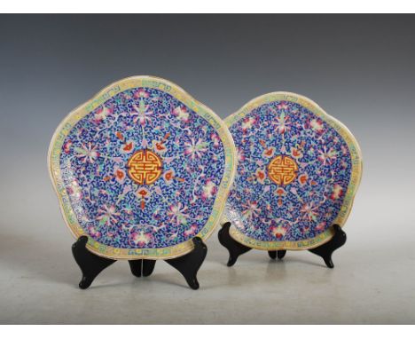 A pair of Chinese porcelain blue ground footed dishes, bearing Jiaqing seal marks but later, decorated with central shou char