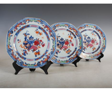 Three Chinese porcelain famille rose octagonal shaped plates, Qing Dynasty, decorated with urn, bottle vase, scroll and peony