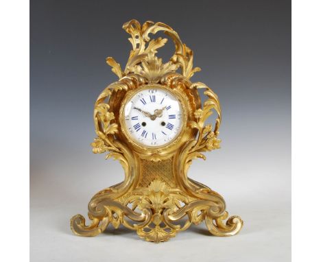 A 19th century French Rococo style ormolu mantle clock of large size, the circular convex dial with Arabic and Roman numerals