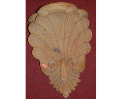A modern carved pine scallop shell form wall shelf