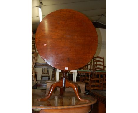 A 19th century mahogany circular tilt top tripod table