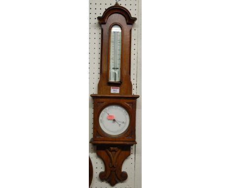 An early 20th century oak aneroid two dial wheel barometer 