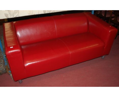 A contemporary red leather two seater sofa