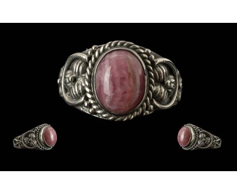 Rhodochrosite Artisan Made Ring, an oval cabochon of the pretty pink stone set in a hand made, decorative, sterling silver mo