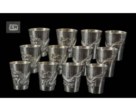 Chinese Export Fine Set of 12 Drinking Tots.  Each decorated with the embossed image of a mythical five claw dragon which cov
