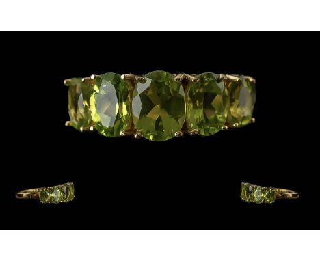 Peridot Five Stone Ring, five oval cut peridots, slightly graduating to either side of the centre stone, in a classic style, 