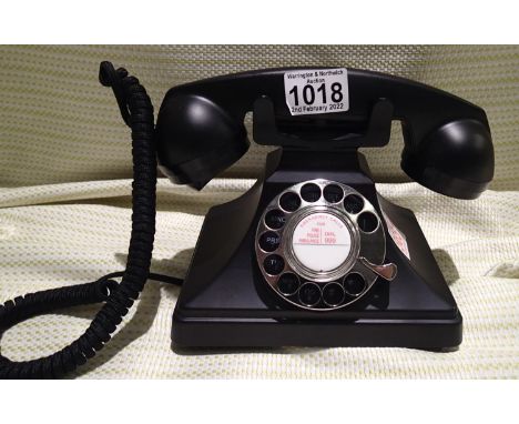 GPO 200 black rotary telephone, has a metal base and handset, traditional cloth handset curly cord and is compatible with sta