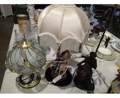Bronzed figural table lamp (lacking shade), a brass and porcelain lamp and a ceramic figural lamp (3). Not available for in-h