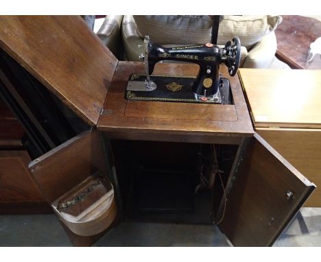 Oak cased two door sewing unit incorporating a Singer sewing machine. Not available for in-house P&amp;P, contact Paul O'Hea 