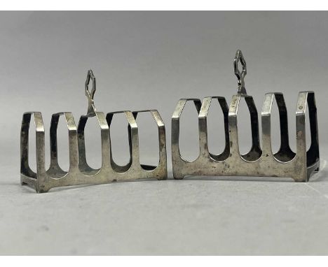TWO SILVER TOAST RACKS,along with caddy spoons, condiment spoons, cigarette case and money clip
