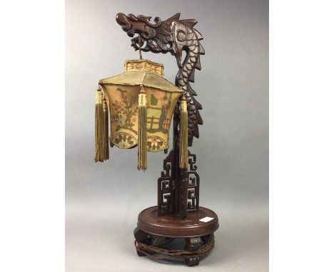 CHINESE WOODEN TABLE LAMP,with fringed shade, 61cm highSome tears present to the shade, some of the wood towards the base is 
