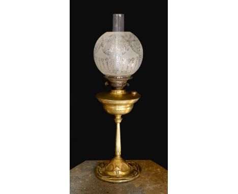 An Edwardian brass oil lamp, with etched glass globe, duplex mechanism and Art Nouveau embossed base, height to top of shade 