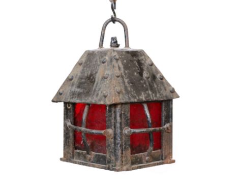 An early 20th century English wrought iron lantern with a red glass panels, height 29cm. width 20cm
***CONDITION REPORT***Oxi