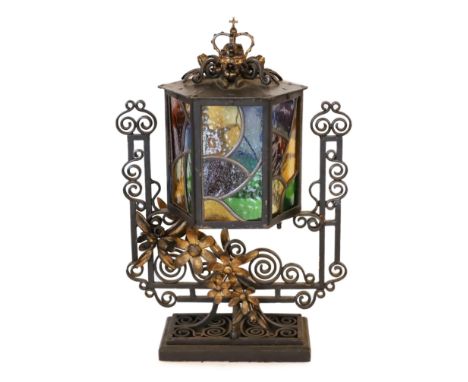 An early 20th century English wrought iron and stained-glass hexagonal lantern style table lamp with crown finial and parcel 