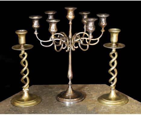 A pair of Victorian brass spiral twist candlesticks and a later seven light candelabrum, candlesticks 27cm. candelabrum 32cm
