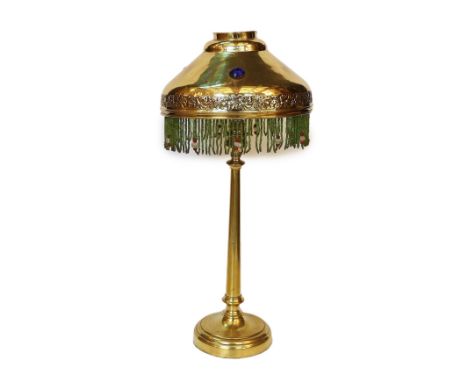 An early 20th century English brass table lamp, the jewelled shade with glass bead fringe, height 45cm
***CONDITION REPORT***