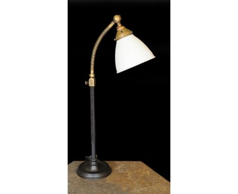 A 1930s English brass wrought iron and cast iron adjustable desk lamp with moulded opaque glass shade, height 66cm
***CONDITI
