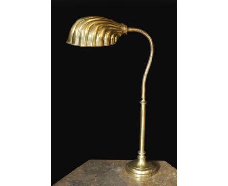 A 1930s English brass adjustable desk lamp, with flexible stem and scalloped shaped shade, height 58cm
***CONDITION REPORT***