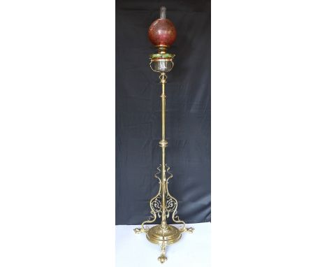 An Edwardian brass telescopic oil lamp standard, with later edged cranberry glass shade and duplex mechanism, height 168cm. w