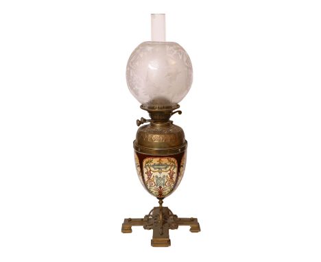 A Victorian brass mounted ceramic oil lamp in the manner of Dalton with brass reservoir and frosted glass shade decorated wit
