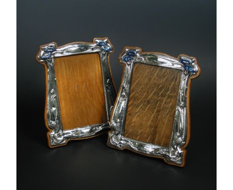 A pair of Art Nouveau silver and enamel photograph frames, by J. Aitkin & Son, Birmingham 1909, each with scrolling foliate m