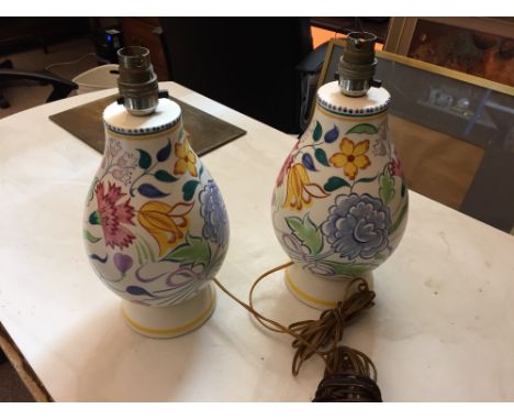A pair of Poole Pottery table lamp bases, the baluster forms painted with flowers and foliage, painted and printed marks 36cm