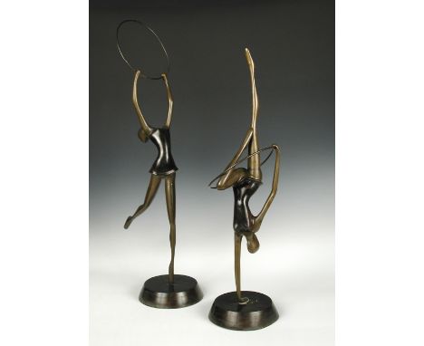 A pair of patinated bronze hoop dancers, each mounted to a spreading circular foot, unsigned (2) 81cm (32in)  