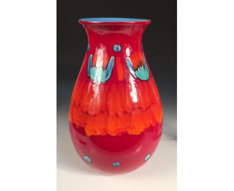 A large modern Poole pottery volcano vase, the bulbous body decorated in greens, blues, reds and oranges, the interior in blu