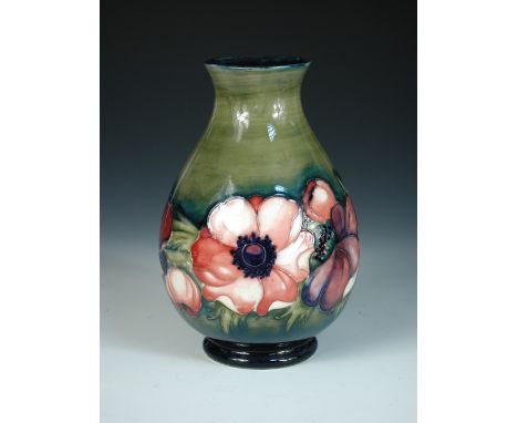 A Moorcroft Anemone pattern vase, circa 1950, the baluster form decorated to a green ground, painted and impressed marks 26cm