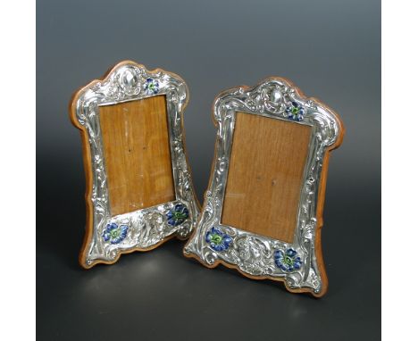 A pair of Art Nouveau silver and enamel photograph frames, by R. U. & Co., Birmingham 1905, each with a central maiden with l