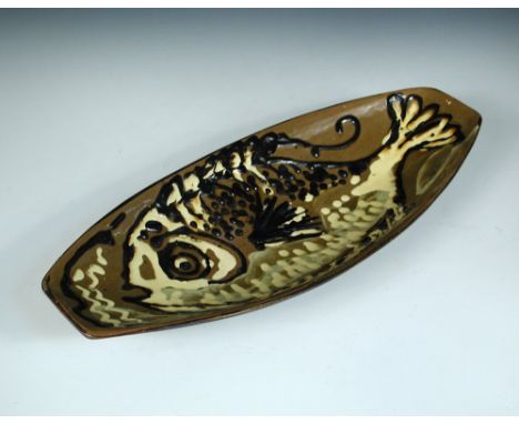 § Thomas 'Sam' Haile (British, 1909-1948), a rare slipware dish, the elongated formdecorated with a fish, impressed seal mark