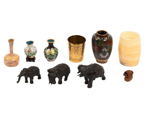 A graduated set of three Japanese bronze elephants, 12cm l and smaller, a Chinese hediao nut carved as a boat, on stand, earl