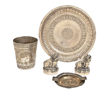 A South East Asian silver repoussé dish, 17cm diam, a similar ashtray and a pair of condiments, 6oz 17dwt weighable and a pla