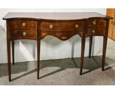 A George III inlaid mahogany serpentine sideboard, with brass lion mask ring handles, on square tapering legs, 95cm h; 160 x 