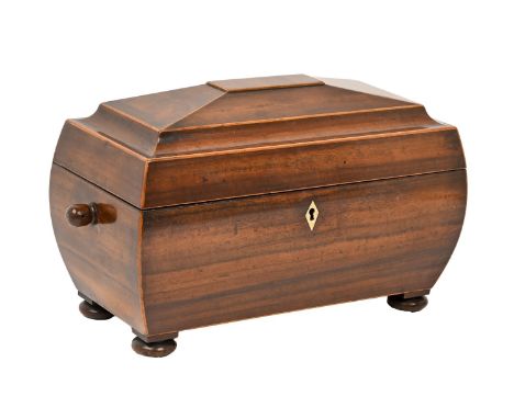A Victorian line inlaid mahogany tea caddy, with ivory escutcheon, on turned bun feet, the interior with twin lidded compartm