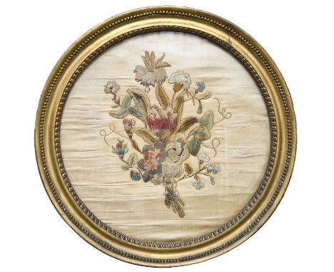 An English silk embroidery of a bouquet, late 18th c, later applied to a silk ground and embellished with gold thread, 40cm d