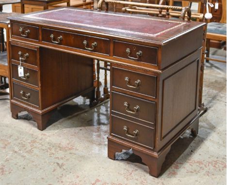 A Victorian style mahogany pedestal desk, tooled red leather top, on bracket feet, 77cm h; 122 x 61cm  Red leather top with m
