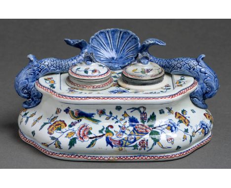 A Gien faience double inkstand, late 19th c, with shell and dolphin surmount, painted with cornucopia and birds, 21.5cm w, pr