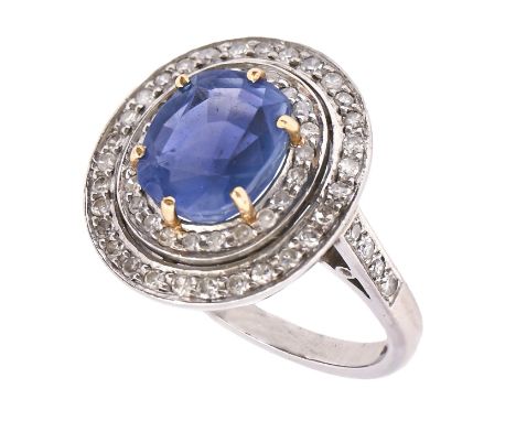 A sapphire and diamond ring, the cushion shaped sapphire approx 9 x 10mm, in concentric surround with diamond shoulders, in p