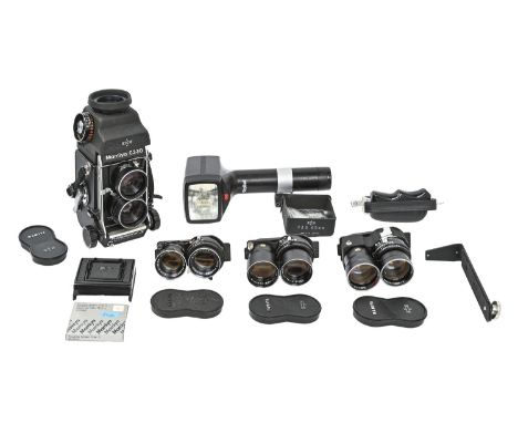A Mamiya C330 twin lens reflex camera, with Mamiya 105mm, 135mm, 180mm and another lens, a Rollei hammerhead flash and bracke