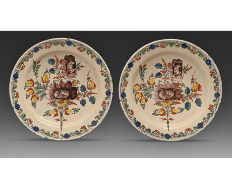 A pair of Dutch Delftware dishes, 19th c, painted in polychrome with stylised flowers in trailing border, 30.5cm diam  Typica