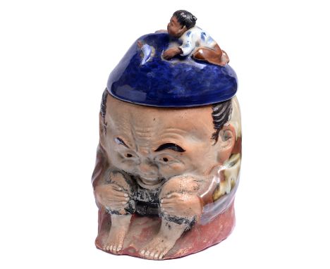 A Japanese Sumidagawa earthenware tobacco jar and cover, Meiji period, modelled as a crouching man with a child climbing over