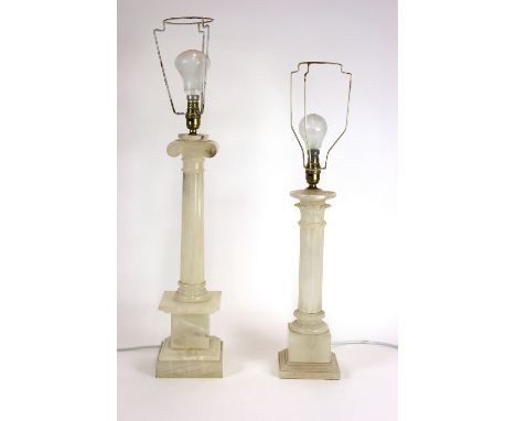 An alabaster lamp base, in the form of an Ionic column, complete with shade, 81cm; and another in the form of a fluted column