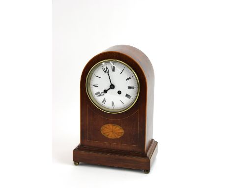 An Edwardian inlaid mahogany mantel clock, white enamel dial, cylinder movement striking on a gong, the case with a fan marqu