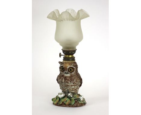 A Victorian porcelain nursery lamp, designed as an owl, encrusted with flowers, complete with opaque glass shade, impressed r