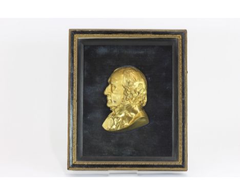 A Victorian gilt metal profile bust length portrait, of William Ewart Gladstone, in a glazed case, 33cm x 28cm overall