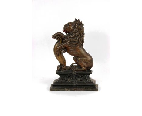 A Victorian Coalbrookdale style cast iron flat back, modelled with a lion rampant, 36cm; bronzed saddled horse applique; a pa